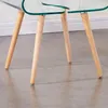 Close-up of the legs of two clear glass tables with wooden legs. Produktbild-Vorschau