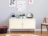 A cabinet with decorative items and a chair in a room. Produktbild-Vorschau