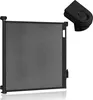 A black retractable baby gate and a black remote control are shown against a white background. Náhled obrázku produktu