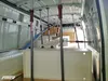 The interior of a van being outfitted with a white shelving unit and several metal support poles with red handles. Produktbild-Vorschau