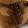 Close-up of a brown plush toy wearing a brown knitted scarf. Podgląd zdjęcia produktu