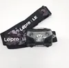 A headlamp with its strap is laid out on a white background. Produktbild-Vorschau