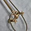 A close-up view of a vintage-style brass shower faucet and showerhead mounted on a tiled wall. Náhled obrázku produktu