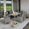 An outdoor patio setting with a dining set and decorative plants. Náhľad obrázku produktu