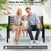 A family of three sitting on a park bench outdoors. Produktbild-Vorschau