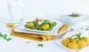 A table setting with plates of food and cups. Produktbild-Vorschau