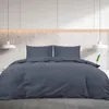 A bed with a duvet and pillows in a modern bedroom setting. Náhľad obrázku produktu