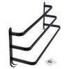 A black metal towel rack with three bars mounted on a white background. Anteprima dell’immagine prodotto