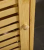 Close-up of a wooden cabinet door with a louvered design and a small wooden knob. Náhled obrázku produktu