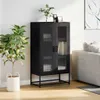 A black highboard with glass doors is placed in a living room setting next to a sofa and a potted plant. Produktbild-Vorschau