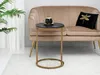 A side table with a marble top and gold legs is placed next to a plush sofa with a decorative pillow. Anteprima dell’immagine prodotto