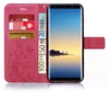 A pink flip phone case with card slots and a phone inserted, displaying a sunset landscape. Produktbild-Vorschau