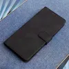 A black flip case for a smartphone is shown on a textured blue surface. Produktbild-Vorschau