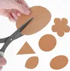 A hand is cutting out cork shapes with scissors. Produktbild-Vorschau