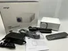 A mini projector, its accessories, and packaging are laid out on a white surface. Produktbild-Vorschau