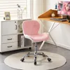 A pink and white ergonomic office chair is placed on a round rug in front of a white cabinet and a wooden desk with a computer. Produktbild-Vorschau