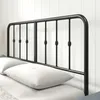 A black metal bed frame headboard with pillows on a bed. Produktbild-Vorschau