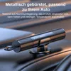A black safety hammer is placed on a dark, textured surface, likely a car interior. Produktbild-Vorschau