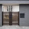 A modern gate with a mailbox attached to a stone wall. Náhľad obrázku produktu