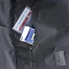 A close-up view of a gray backpack pocket with a card and tissues inside. Náhľad obrázku produktu