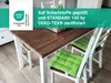 A wooden dining table with green chair cushions. Produktbild-Vorschau