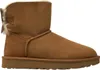A single brown Ugg boot with a bow on the back, shown from the side against a white background. Produktbild-Vorschau