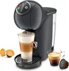 A dark gray Nescafé Dolce Gusto coffee machine with a glass of latte macchiato and two espresso cups with coffee pods. Produktbild-Vorschau