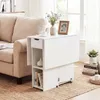 A white drop-leaf table is placed next to a beige sofa, with books and decorative items on and around it. Náhľad obrázku produktu