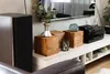 A living room scene featuring a TV stand with decorative items and electronics. Anteprima dell’immagine prodotto