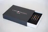 A dark gray box with the Lana Grossa logo and text is partially open, revealing a set of colorful knitting needles inside. Produktbild-Vorschau