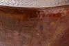 A close-up view of a hammered copper table surface. Produktbild-Vorschau