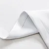 A close-up view of white fabric, showing the texture and stitching of a hemmed edge. Produktbild-Vorschau