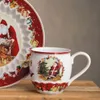 A close-up shot of a Christmas-themed mug and plate. Voir les images du produit