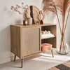 A wooden sideboard with rattan detailing, styled with decorative objects and dried flowers. Anteprima dell’immagine prodotto