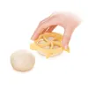 A hand is holding a yellow dough cutter over a piece of dough, with another piece of dough to the side. Náhľad obrázku produktu