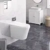 A modern bathroom with a wall-mounted toilet, a white vanity with a vessel sink, and dark marble flooring. Produktbild-Vorschau