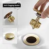 A close-up collage showing a brass pop-up drain assembly for a sink, with a hand demonstrating its installation. Produktbild-Vorschau