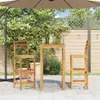 A wooden bar table and two bar stools are set up on a patio under a large umbrella. Anteprima dell’immagine prodotto
