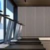 A row of treadmills in a modern gym with a large window overlooking a city. Náhľad obrázku produktu