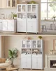 A collage showing two identical white storage cabinets with glass doors, displayed in different room settings. Náhled obrázku produktu