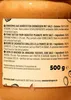 A close-up of a label on a jar of peanut butter, showing ingredients and nutritional information in multiple languages. Produktbild-Vorschau