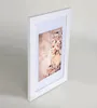 A framed picture of a woman adorned with flowers. Produktbild-Vorschau