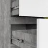 Close-up view of a modern chest of drawers with concrete-effect sides and white fronts, showing the drawer slides. Produktbild-Vorschau