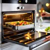 A person is adding seasoning to a pan of vegetables in an open oven. Náhľad obrázku produktu