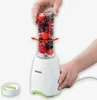 A person is holding a blender cup filled with berries, and another person's hand is on the base of the blender. Produktbild-Vorschau
