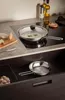 A kitchen scene with cookware on a stovetop and in a drawer. Podgląd zdjęcia produktu