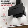 A black kitchen range hood mounted on a wall above a countertop with kitchen utensils and cookware visible. Produktbild-Vorschau