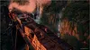 Two people are walking on a damaged train bridge over a gorge with waterfalls. Náhled obrázku produktu