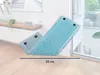 A blue mop head is shown lying on a wooden floor, leaning against a white wall. A window is visible in the background. Produktbild-Vorschau