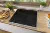 A modern kitchen induction hob with a pot of food and a plant. Anteprima dell’immagine prodotto